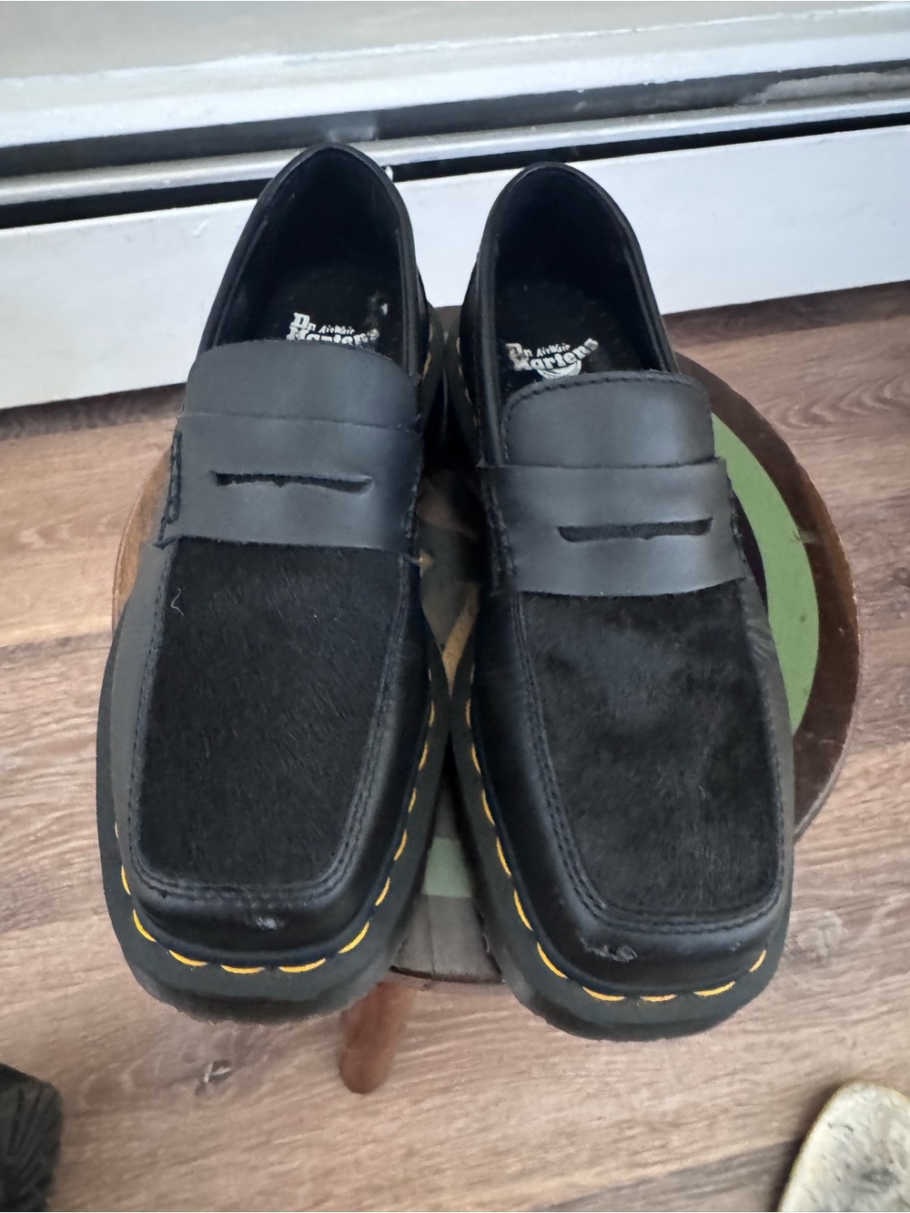 Dr. Martens Black Ponyhair Penny Loafers with Yellow Welt Stitching